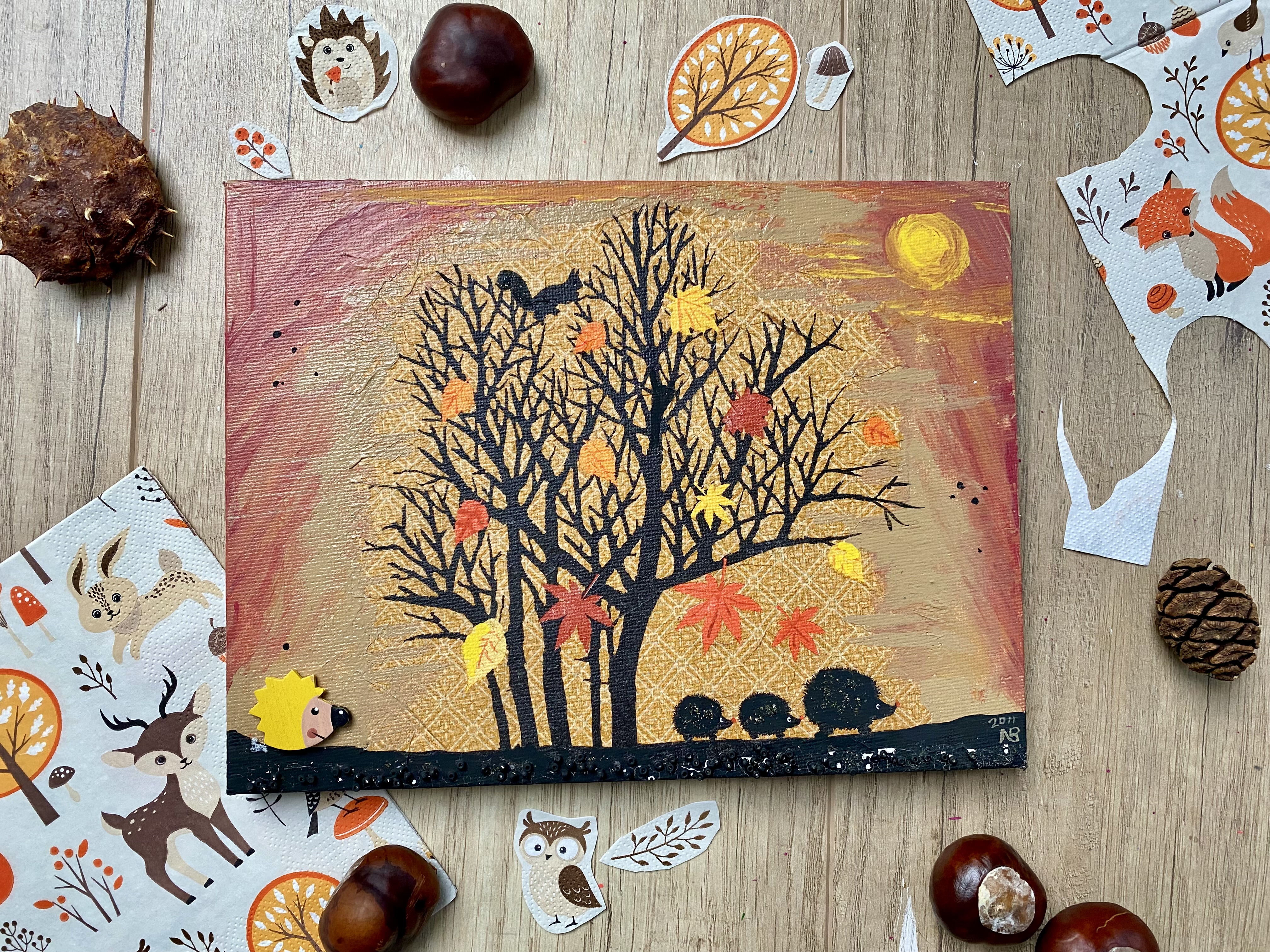 Ockerfarbenes Bild mit schwarzem Baum und Igeln