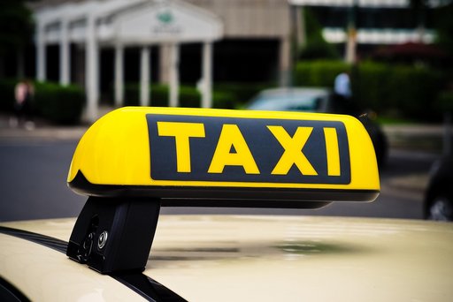 Ein Autodach auf dem ein gelbes Taxischild montiert ist.